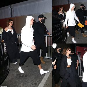 What shoe you mean? Justin Bieber ditches his trainers and hurriedly strolls in just his white socks as he and wife Hailey depart the Super Bowl